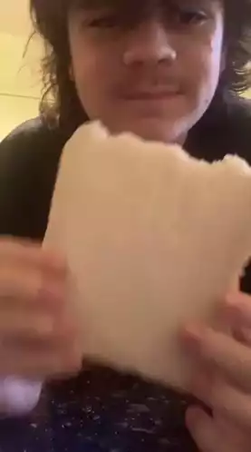 Young Man Eating Atlas Bread