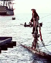 Pirate Standing on Boat Mast at Sea