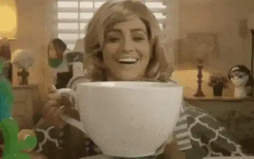 Woman Drinks from Giant Coffee Cup
