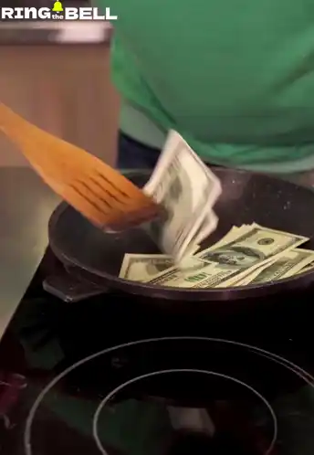 Man Cooking Dollar Bills in a Pan