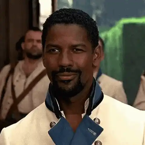 Denzel Washington smiles and points