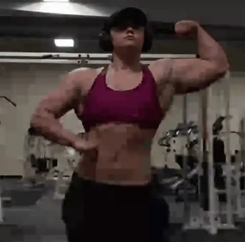 Dylan Crenshaw Flexes Biceps in Gym