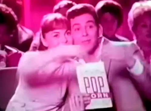 Couple Eating Popcorn at Movie Theater