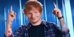 Ed Sheeran Points Up in Plaid Shirt