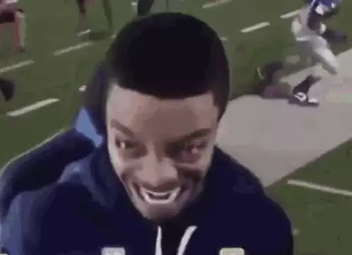 Funny Man's Intense Smile on Football Field