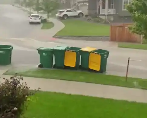 Garbage Cans Floating in Heavy Rain