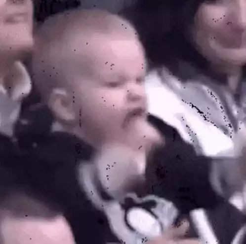 Excited Baby Cheering at Game